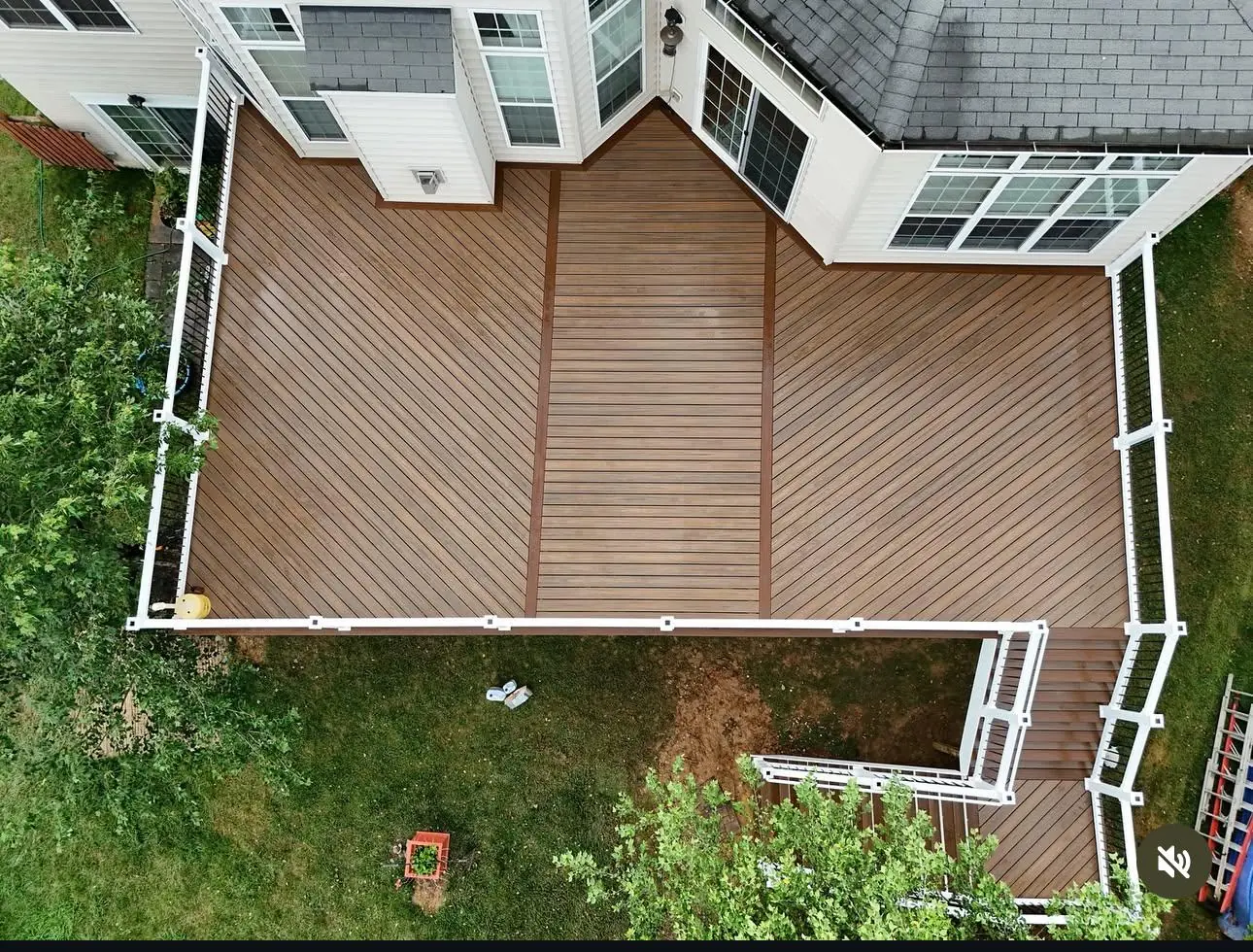 Aerial view of diagonal-pattern composite deck with white vinyl railings and herringbone border